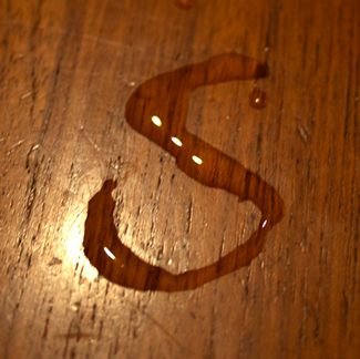 The S from the Spritzer logo, written with water